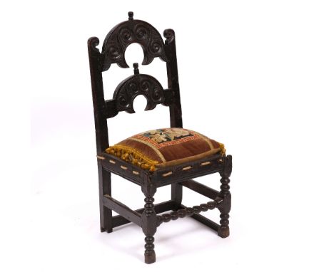 A 17TH CENTURY YORKSHIRE / DERBYSHIRE OAK CHAIR 46cm wide x 103cm high together with an antique tapestry cushion (2)