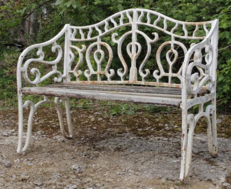 A WHITE PAINTED CAST IRON GARDEN BENCH with wooden slatted seat, 105cm wide x 85cm high