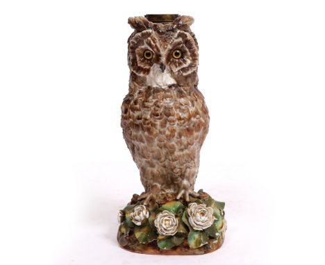 A VICTORIAN PORCELAIN OIL LAMP BASE moulded and painted in the form of a tawny owl resting on a floral bank with impressed re