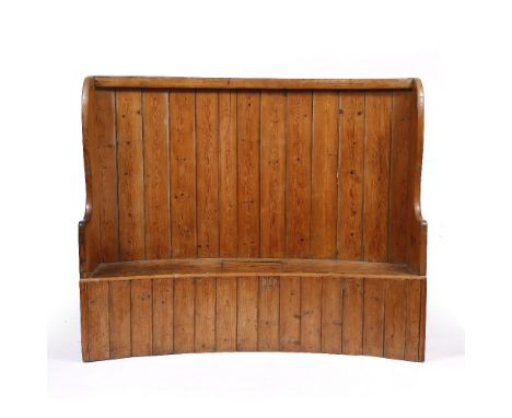 AN ANTIQUE WELSH CURVING PINE SETTLE with box seat, 151cm wide x 38cm high