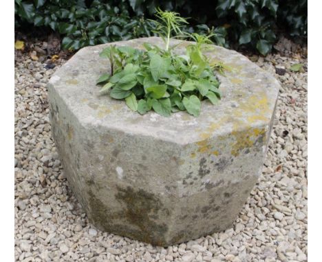 AN OLD OCTAGONAL CARVED STONE PLANTER 56cm wide x 35cm high 