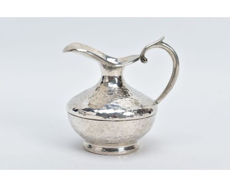 A WHITE METAL JUG, of a hammered design, scroll handle, stamped 925 to the base, approximate gross weight 3.70ozt, 115.3 gram