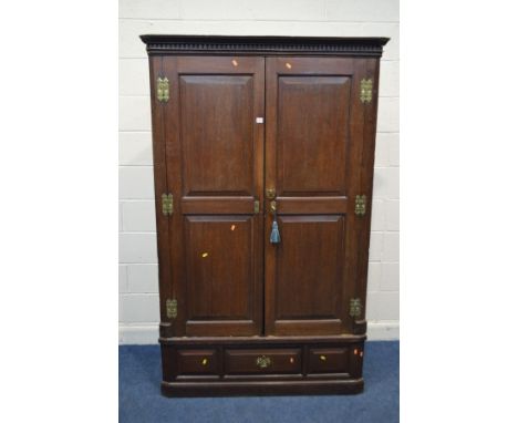 A LARGE GEORGE III OAK FREE STANDING TWO SECTION CORNER CUPBOARD, with double fielded panel doors enclosing a single fixed sh