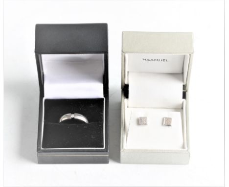 A titanium diamond solitaire ring, set with a round brilliant cut diamond, measuring approx. 0.08ct, together with a pair of 