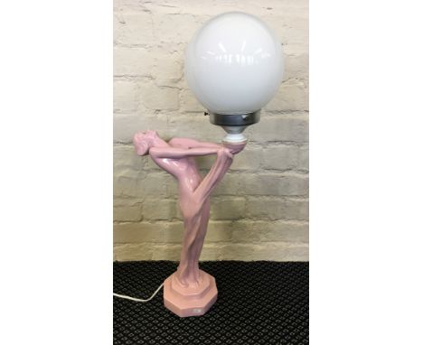 A pink Art Deco style female form light with white globe shade.
