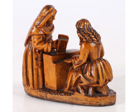Of a nun standing over a lady playing an instrument 7.5cm long, 7cm high.
