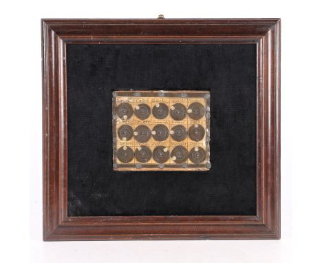 Designed as three rows of five metal discs, each designed to rotate with an aperture over a series of numbers, and each inscr