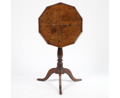 The ten-sided top with moulded edge, on a baluster-turned pillar and three hipped downswept legs with pad feet, 49cm diameter