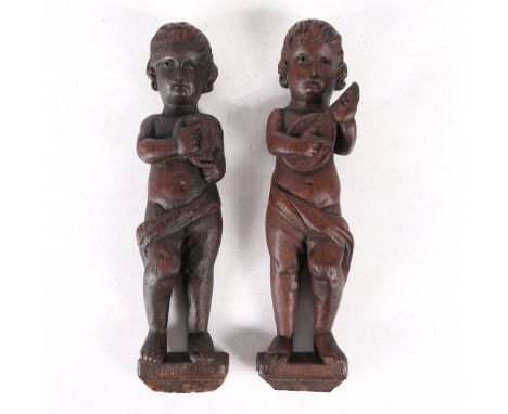 modelled as two putti playing musical instruments, 36cm high, (2).