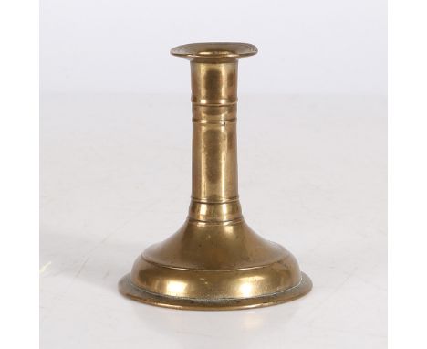 With flared socket flange above a stem cast with two band knops, on a spreading circular foot with narrow footrim, height 12.