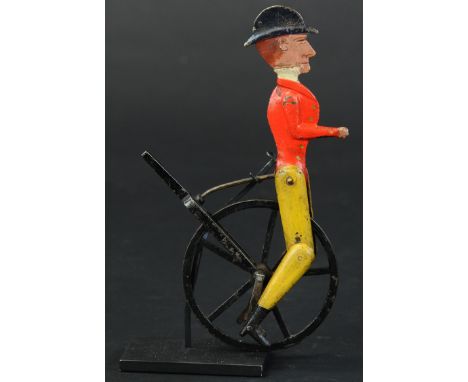 340. MAN RIDING HIGH WHEEL | Early hand painted cast iron toy, action involves legs moving up and down when moved along by st