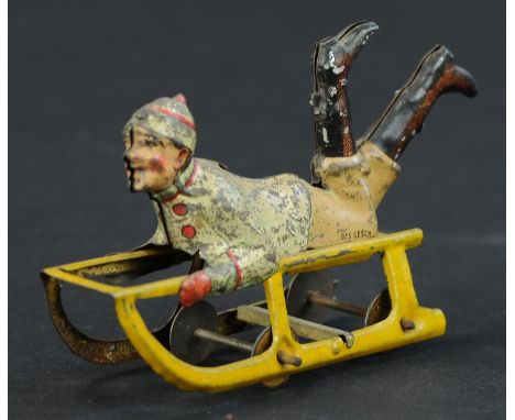 40. MEIER BOY ON SLED PENNY TOY | Provenance: Paul Cole Collection. | 3.25" l. | (Excellent Condition) | $200 - $400
