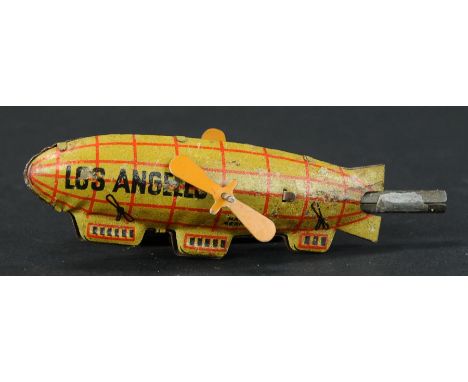 36. LOS ANGELES DIRIGIBLE WHISTLE PENNY TOY | Germany. | Provenance: Paul Cole Collection. | 4.5" l. | Two replaced props, ot