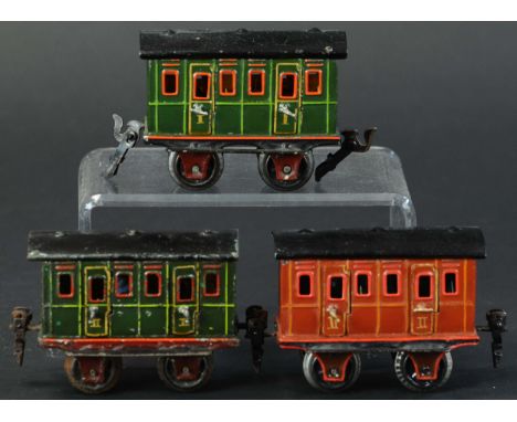 768. THREE MARKLIN PASSENGER CARS | O gauge, hand painted, four opening doors on each car. Provenance: Paul Cole Collection. 