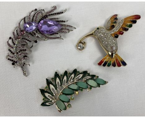 3 large costume jewellery statement brooches. An enamel and stone set humming bird, a leaf design set with varying green ston