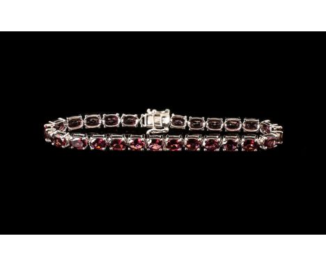 Garnet Tennis Bracelet, 23.5cts of the deep red garnet with generous flashes of dark pink, rhodolite garnet, oval cut and set