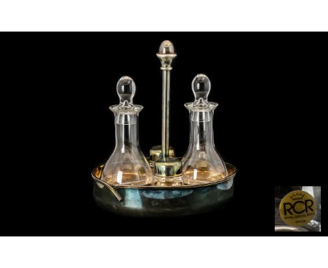 Italian Designer Condiment Set housed in a silver plated cradle, with unusual central handle consisting of oil and vinegar bo