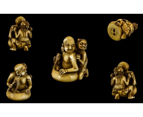 Indian 19th Century Excellent Quality Carved Ivory Netsuke - depicts the master holding a whip with his demon servant to his 