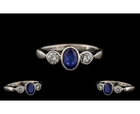 18ct White Gold - Attractive Sapphire and Diamond 3 Stone Dress Ring From the 1950's. The Central Oval Shaped Sapphire with P