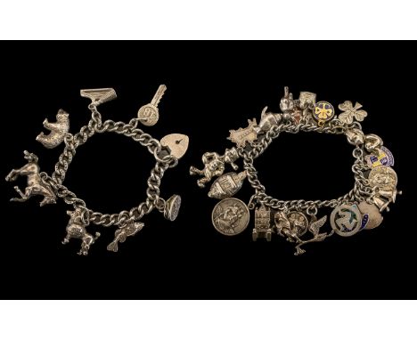 A Pair of Silver Vintage Charm Bracelets ( 2 ) In Total. Loaded with 28 Silver Charms, Some Early Charms. All Marked for Ster