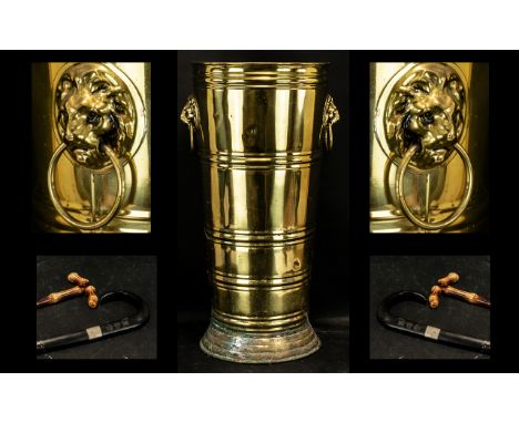 Large Vintage Brass Umbrella Stand with a lion's head either side holding a ring in the mouth. Measures 21" height.  Also inc