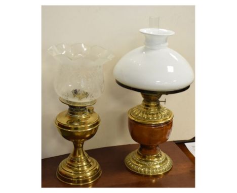 Late 19th/early 20th Century brass oil lamp having pottery reservoir and one other brass oil lamp, both with shades  