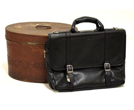 Vintage oval metal hat box with hinged cover and black holdall  