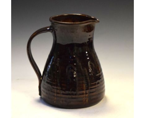 Margaret Leach - Mid 20th Century studio pottery jug of ribbed bulbous form with brown treacle glaze, impressed marks, 21.5cm