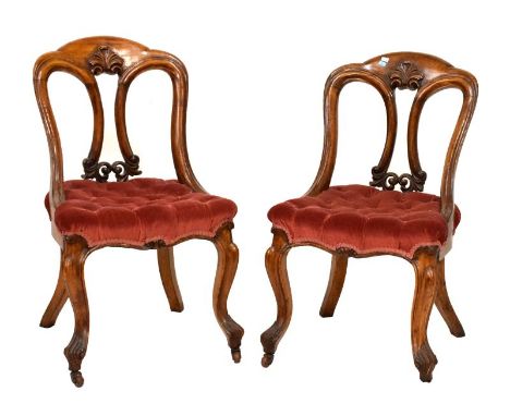 Pair of Victorian oak carved dining chairs having acanthus carved back, upholstered button seat raised on cabriole supports f