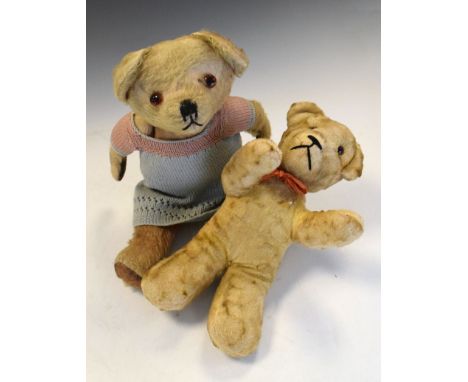 Two golden plush vintage teddy bears, one of which wearing dress, largest measuring 33cm high  