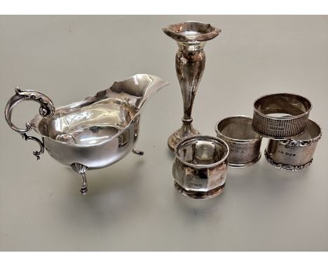 A Chester silver basket weave napkin ring, a Birmingham silver engine turned decorated napkin ring, a Chester silver chased b