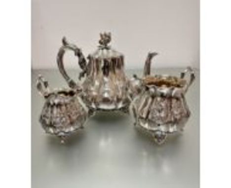 A Victorian Epns three-piece panelled baluster tea service with floral finial and scroll handle to side, raised on scroll sup