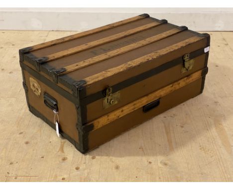 An early 20th century wood and metal bound steamer trunk, with carry handle to each end, H334cm, W77cm, D48cm