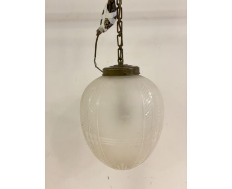 An Edwardian style ceiling pendant light fitting, with brass rose and chair supporting an etched and moulded glass shade of o