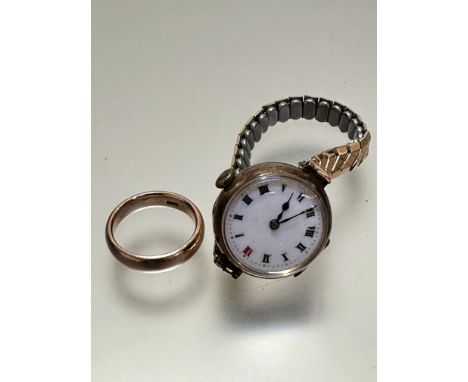 A Ladies vintage 9ct gold wristwatch with enamel dial and roman numerals on expanding metal bracelet and a yellow metal weddi