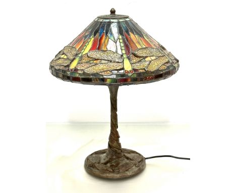 A modern bronzed verdigris finished Tiffany style lamp with dragon fly leaded glass conical shade, on spiralling stem and dra