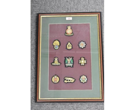Regimental bullion badges nicely presented in Ray Carpenter Gallery frame 56cm x 40cm and comprising ten badges including Roy