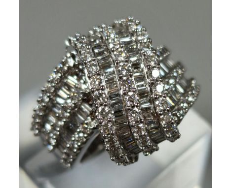 18ct white gold diamond cross-over ring, having round brilliant cut and baguette diamonds, measuring approximately 2.1 carats