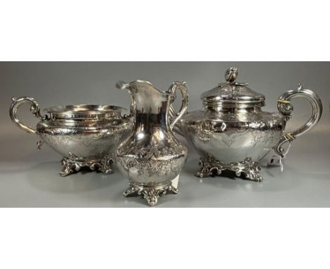 Victorian three piece tea service, ornately engraved, to include: baluster teapot with bud finial, two handled sucrier and cr