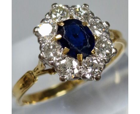 18ct gold diamond and sapphire multi-cluster flowerhead ring, the central sapphire stone surrounded by an arrangement of eigh