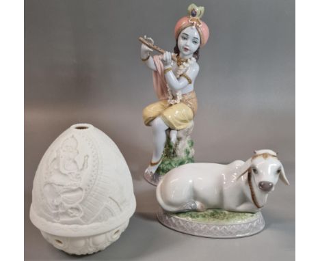 Lladro Spanish porcelain figurine of Krishna with Flute. 21.5cm high approx. together with a Lladro recumbent sacred Cow and 