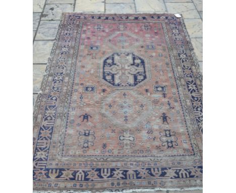 An Eastern carpet, with stylised motifs on a red ground, within a multi border, 254 x 174 cm