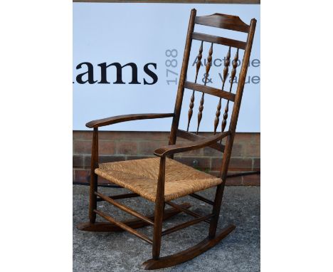 Neville Neal Ash rocking chair, circa 1960 ladder-back with stylised supports, rush seat stamped to leg 105cm high