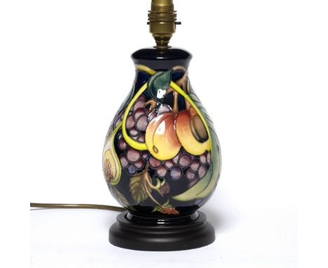 Moorcroft Pottery Lamp base tube lined decoration, wooden base factory marks to underside 28cm high