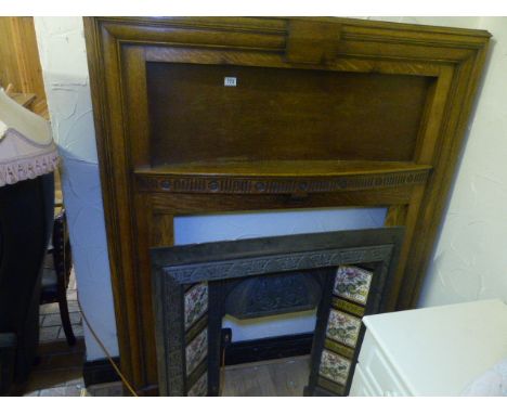 OAK FIRE SURROUND. Oak period fire surround with fender and cast iron tiled inset, 134 x 163cm 