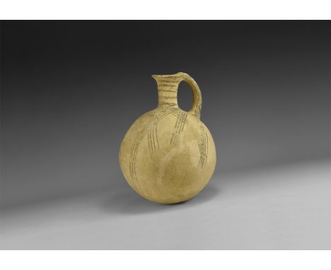 2nd millennium BC. A ceramic vessel with globular body, trumpet-shaped neck and everted rim, D-section strap handle, intersec