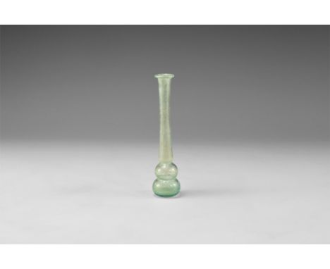 1st-3rd century AD. A delicate pale blue unguentarium with waisted bulb, tapering stem, folded rim. Cf. Whitehouse, D. Roman 