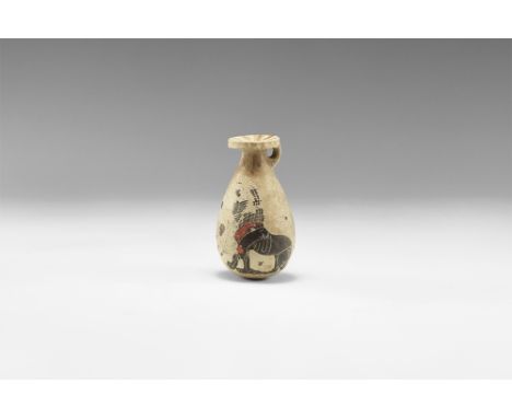 7th-6th century BC. A ceramic alabastron with rounded body, discoid mouth with loop below, painted radiating strokes to the m