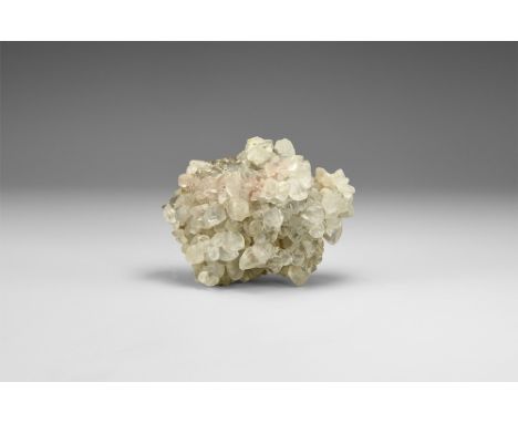 A group of calcite crystals coating a nodular mass of limonite, the crystals exhibiting mixed forms, including scalenohedrons