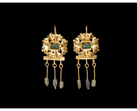 2nd-3rd century AD.A matched pair of gold earrings, each an openwork plaque of radiating ivy-leaf motifs around a twisted wir